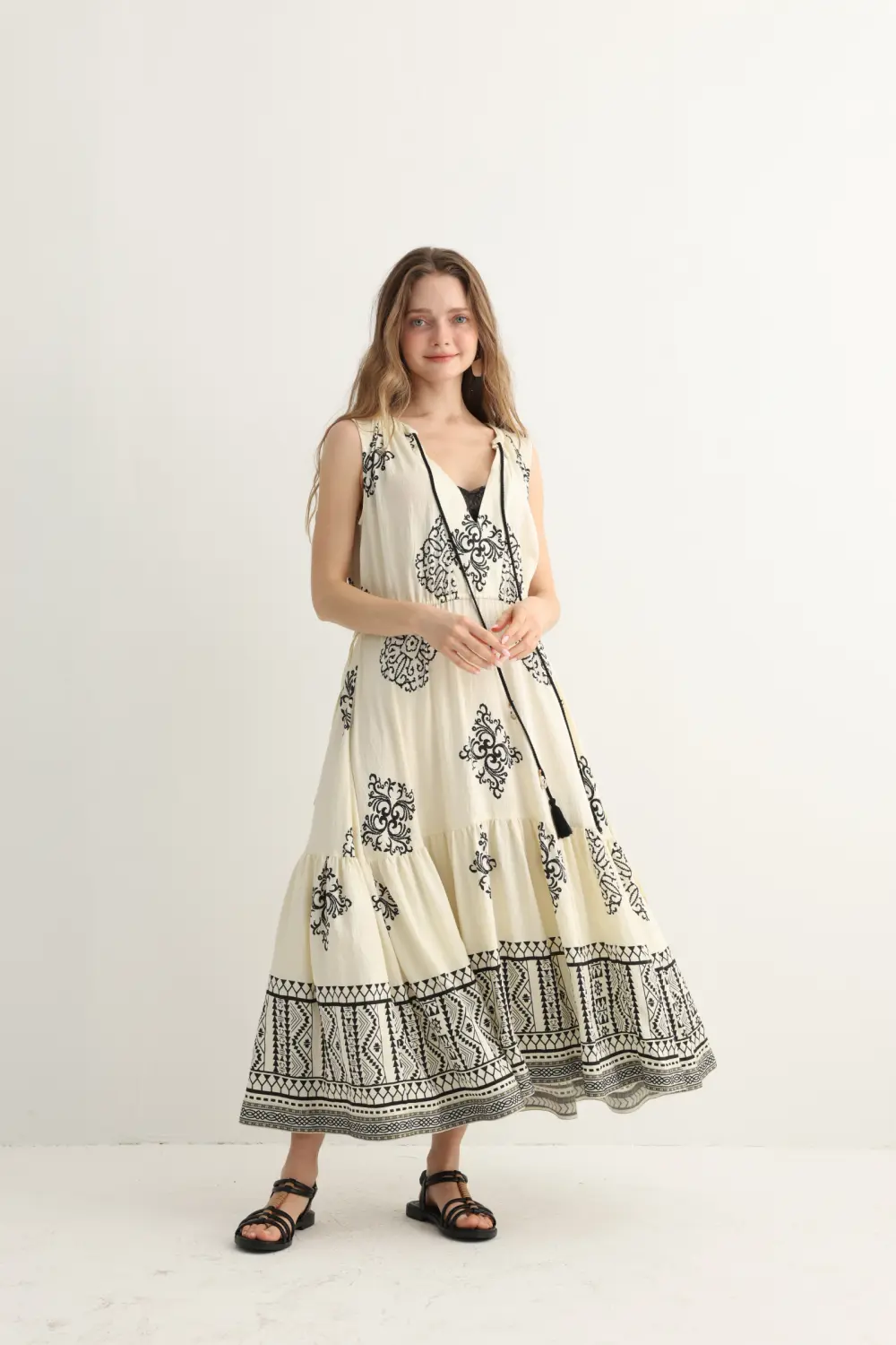 black geometric embroidery detail on cream maxi dress