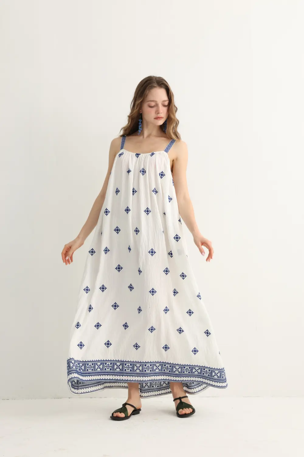 navy floral embroidery on Greek-inspired white maxi dress