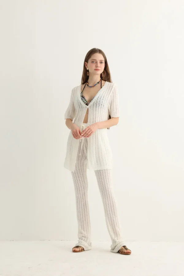 White open-knit beach set with longline top and flare pants