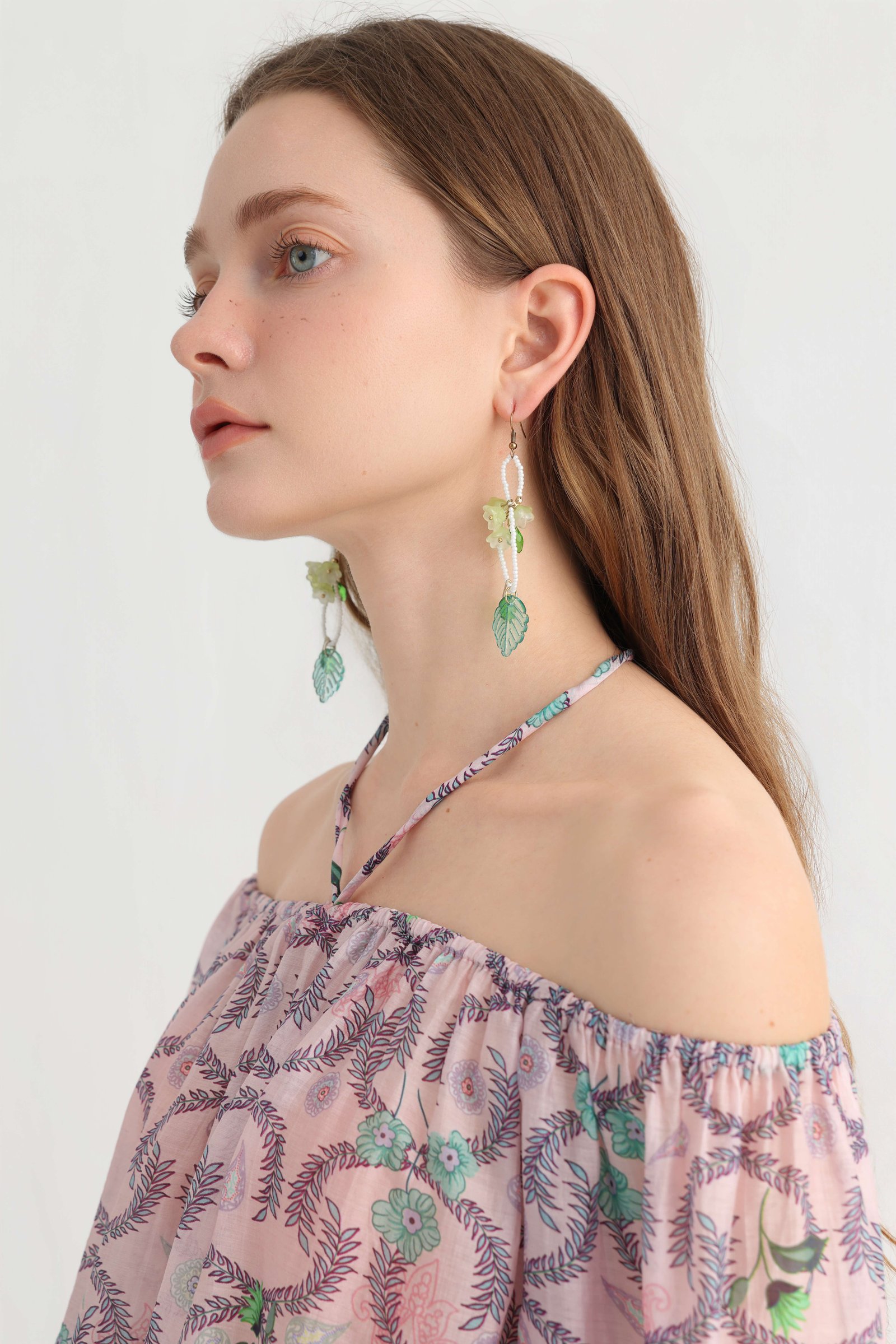 Detail of the off-shoulder neckline and slim halter tie