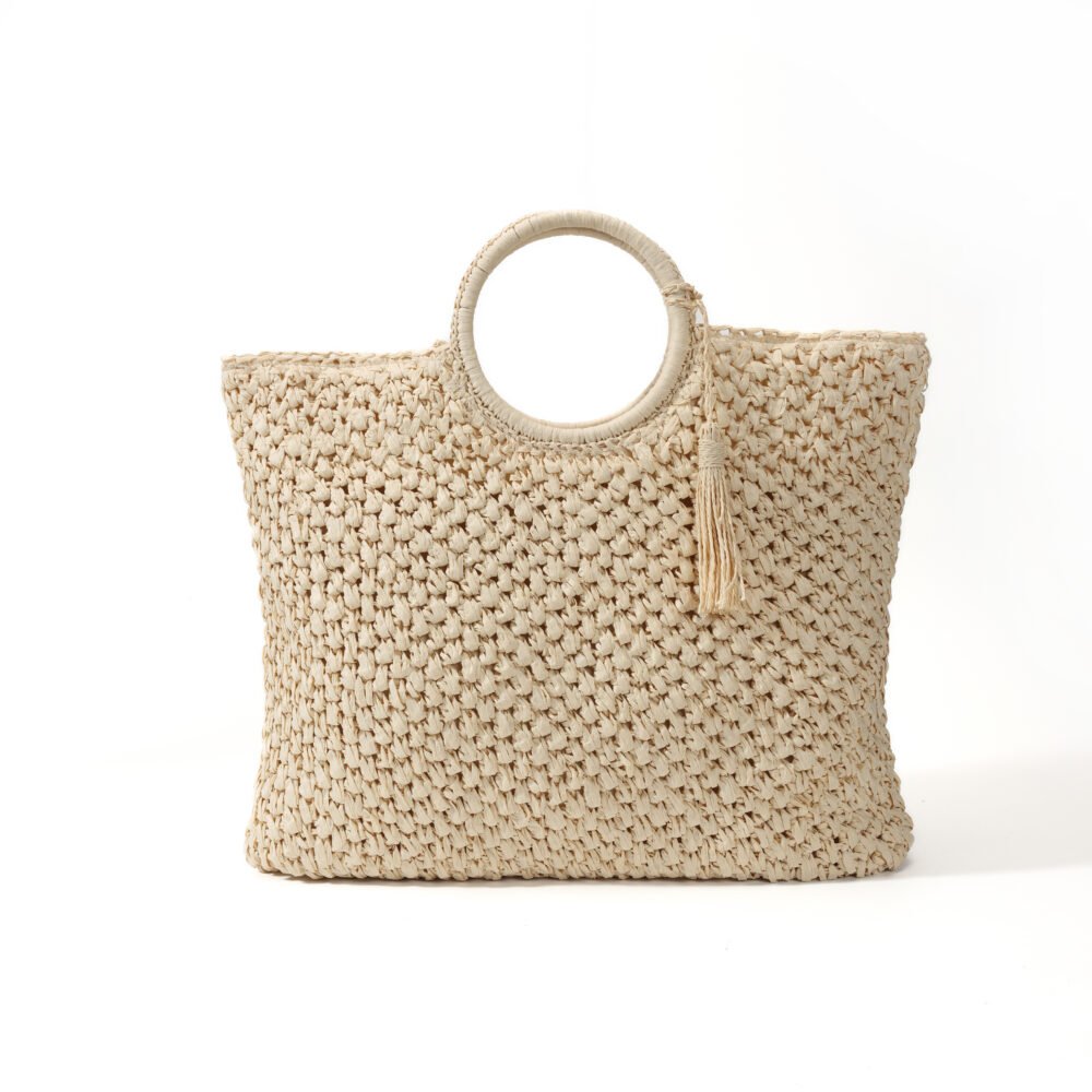 Round handle straw tote bag with natural openwork texture and matching tassel