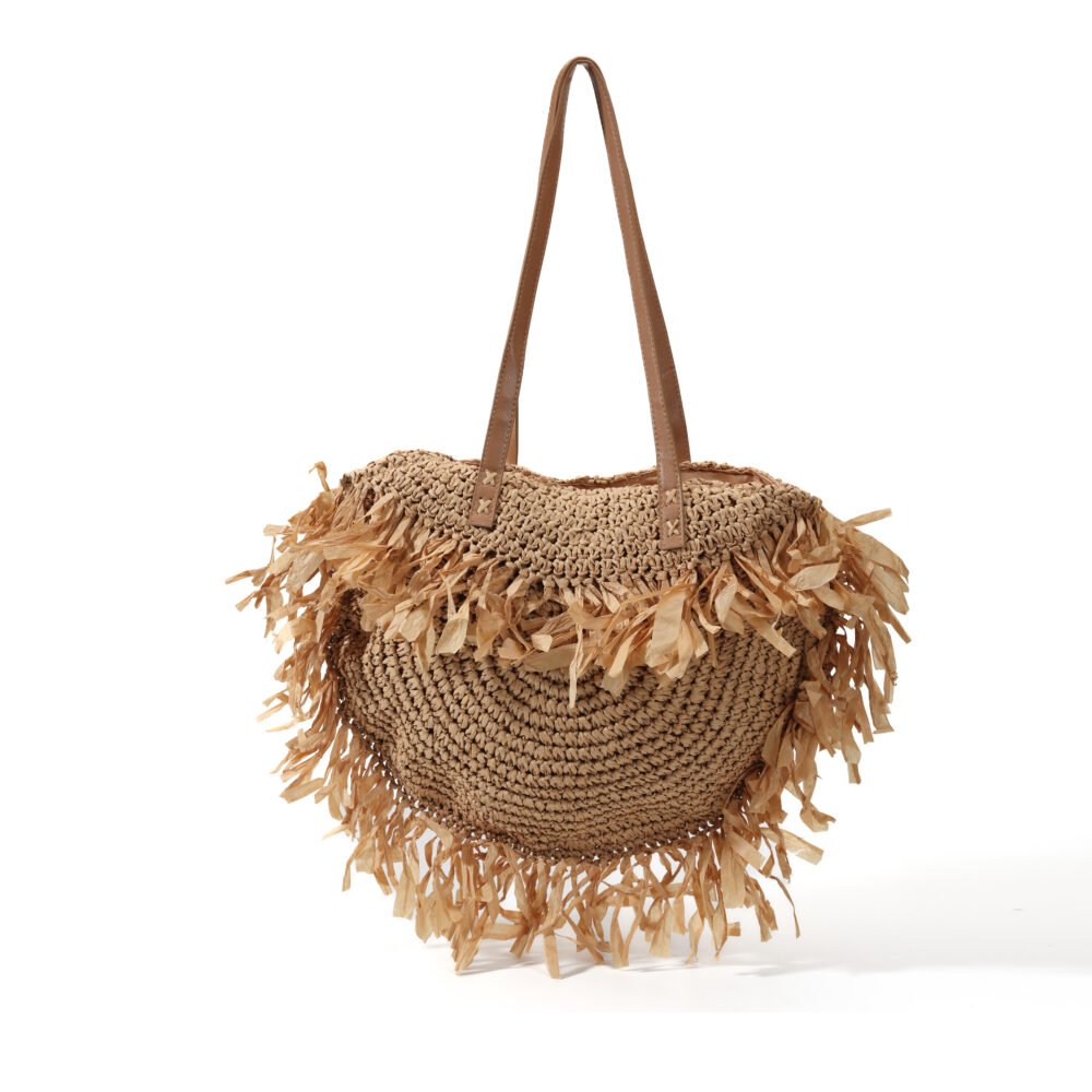 Raffia fringe shoulder tote bag with rounded woven body and long brown straps
