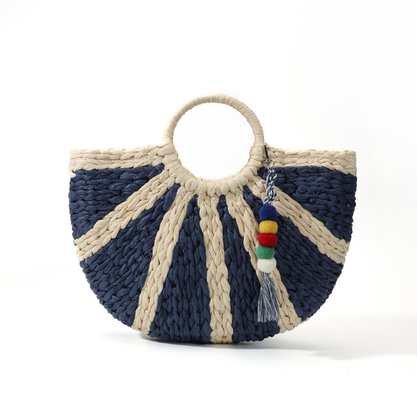 Navy striped straw tote bag with half-moon shape and pom-pom tassel charm