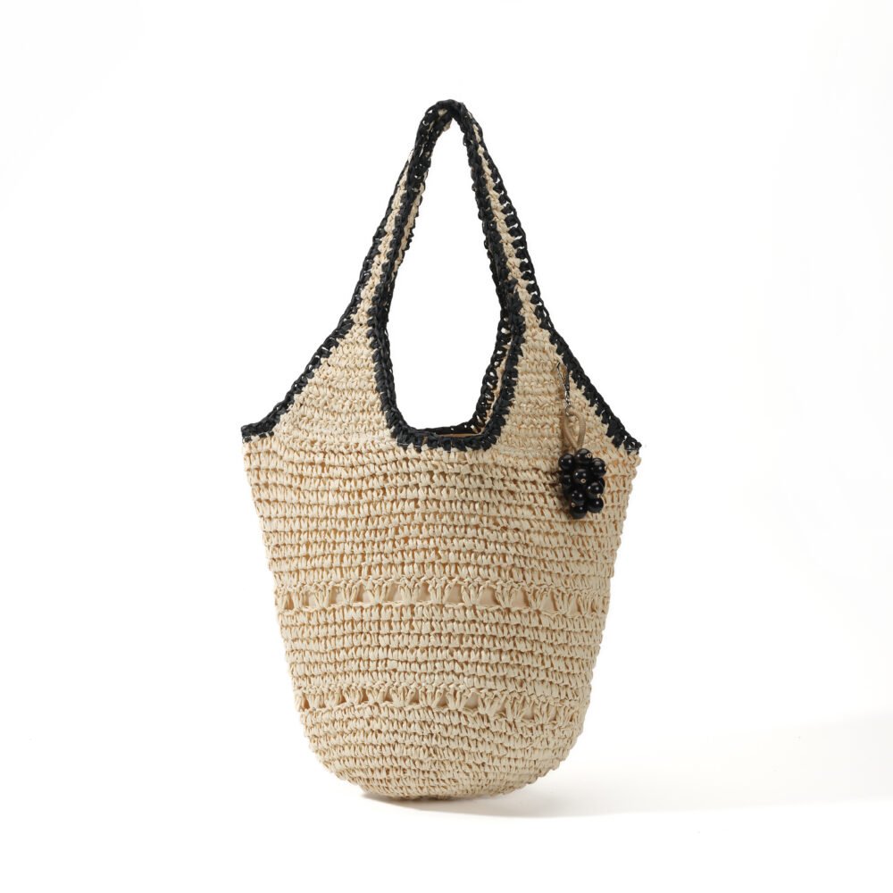 Black trim straw tote bag with wide handles and clustered bead charm