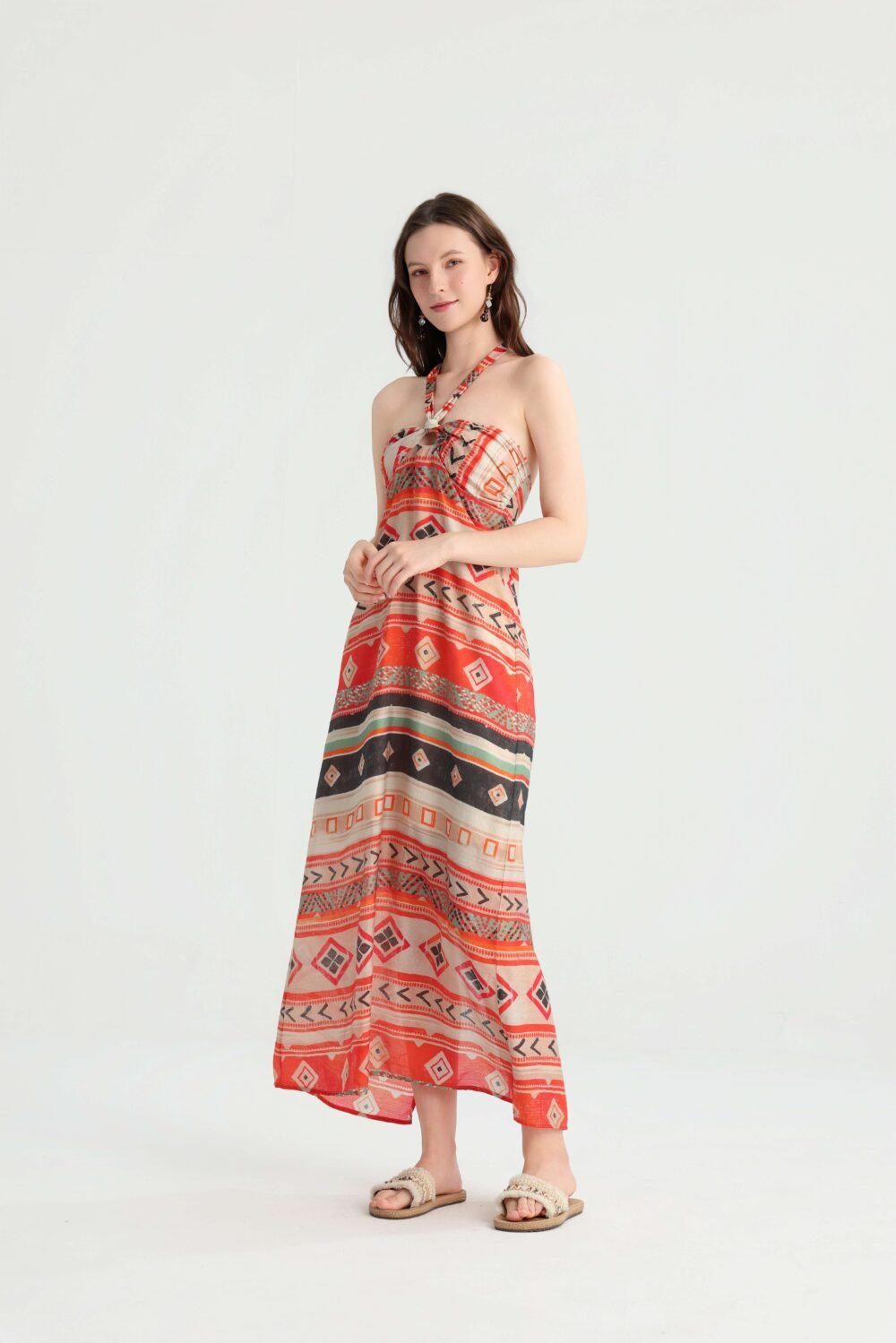 Angled front view of the red-orange geometric maxi dress