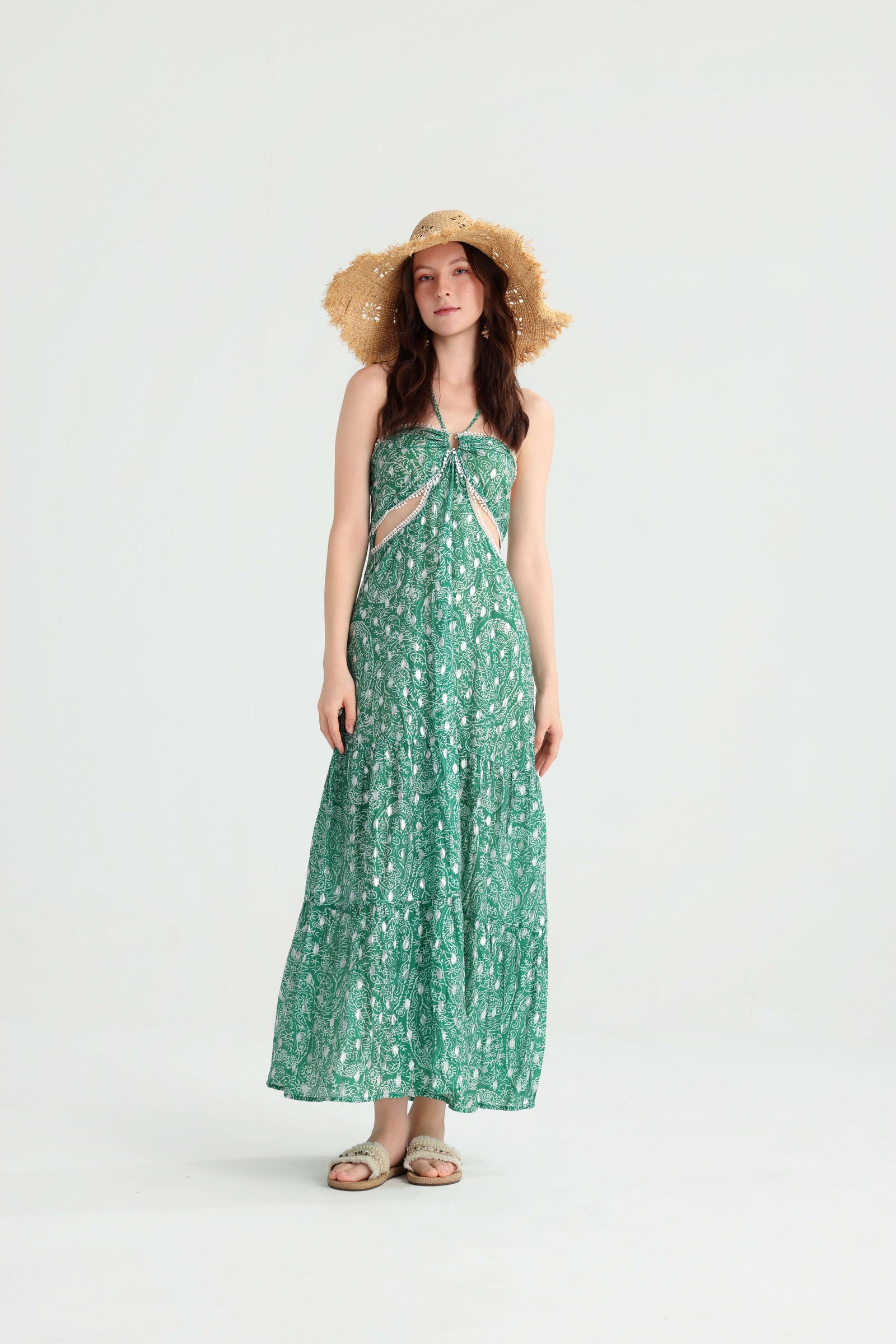 Front view of the green halter maxi dress with a flowing skirt