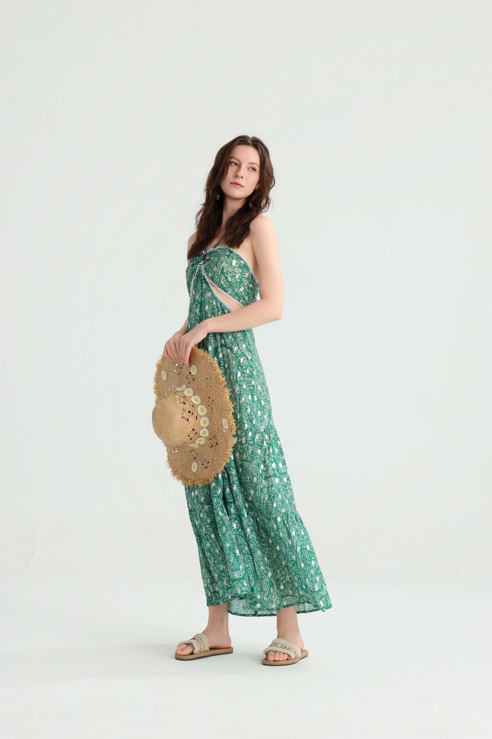 Side pose with a straw hat in the green paisley maxi dress