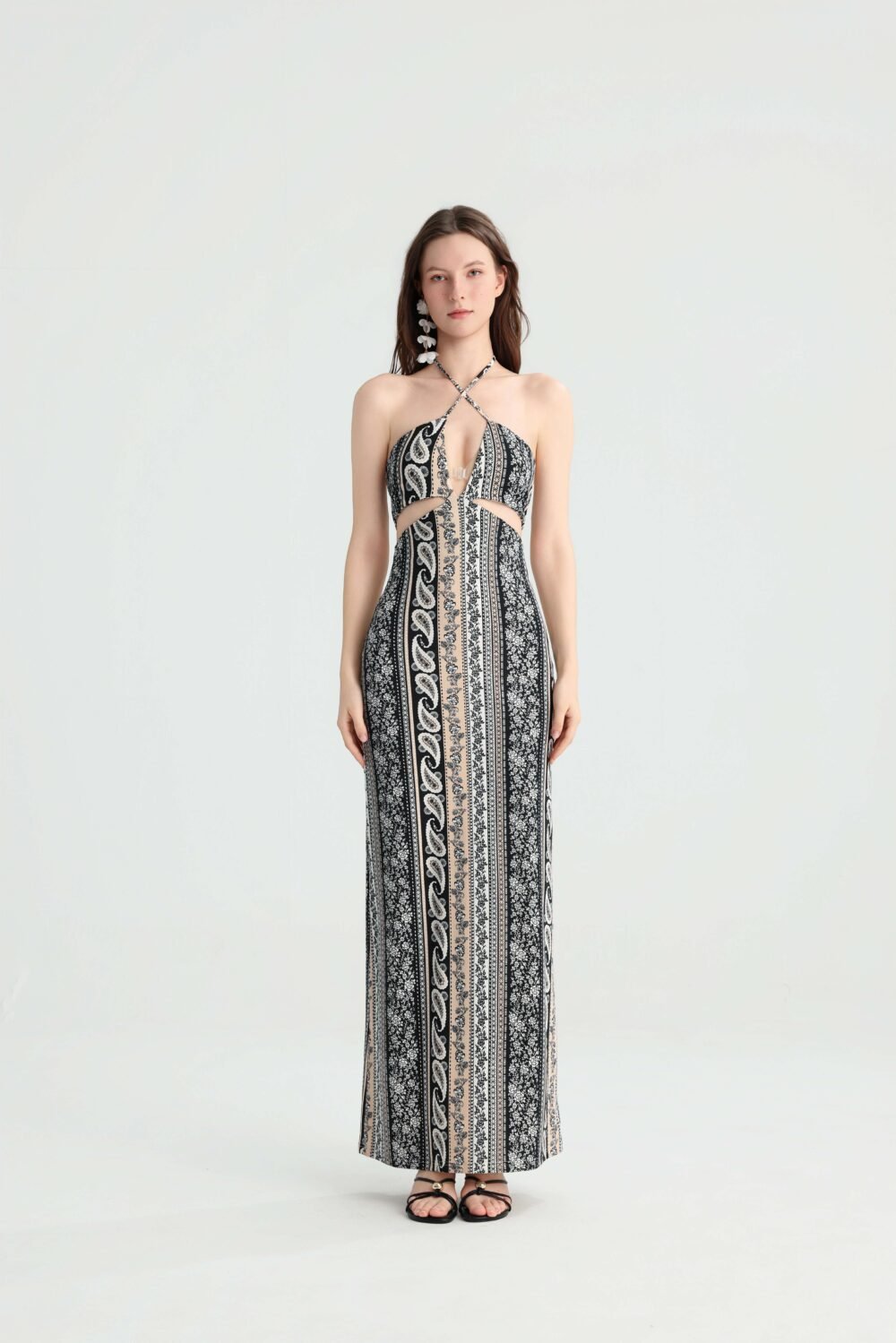 Front view of a black paisley cutout maxi dress