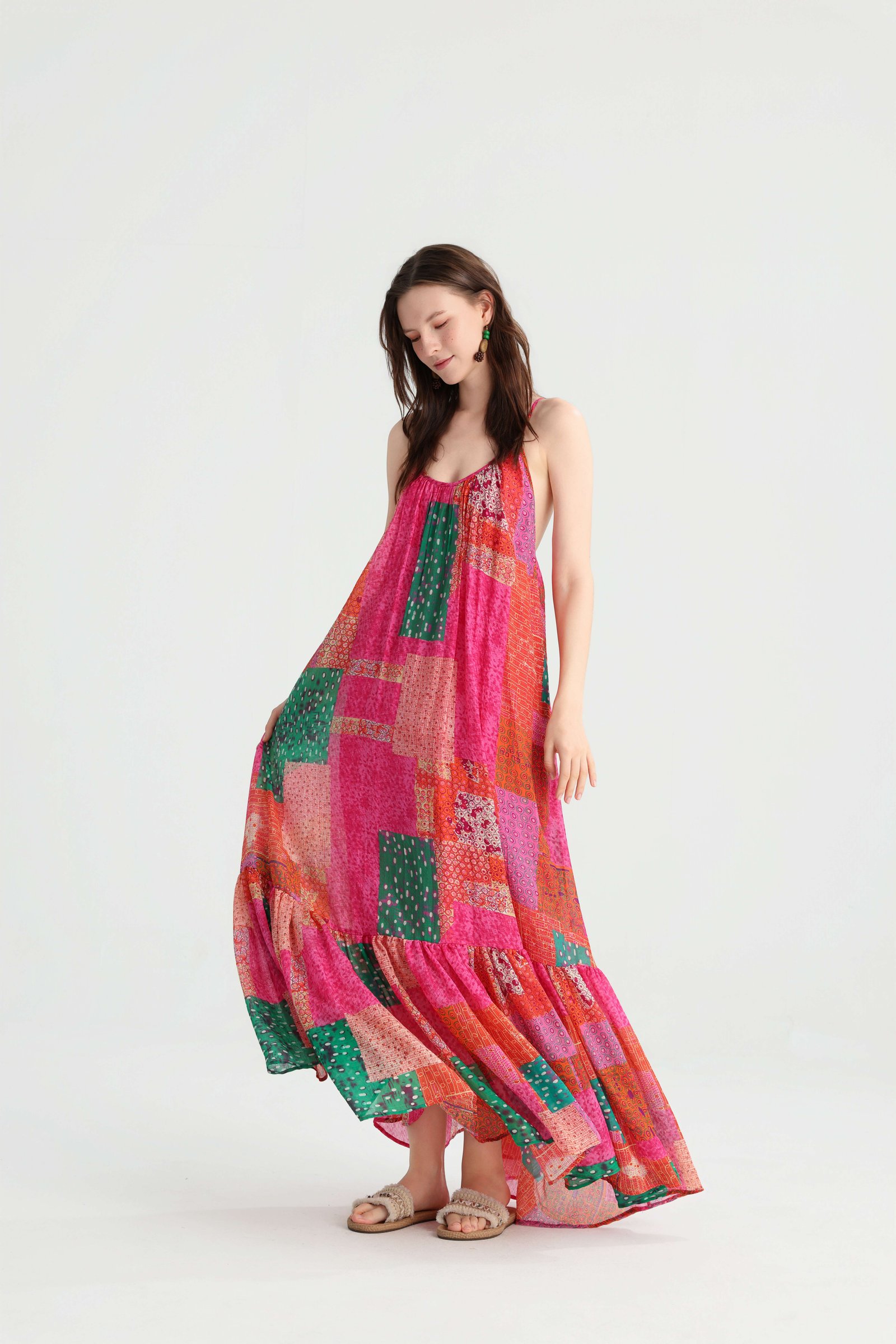 Model looking down as the pink, orange and green skirt billows around her legs