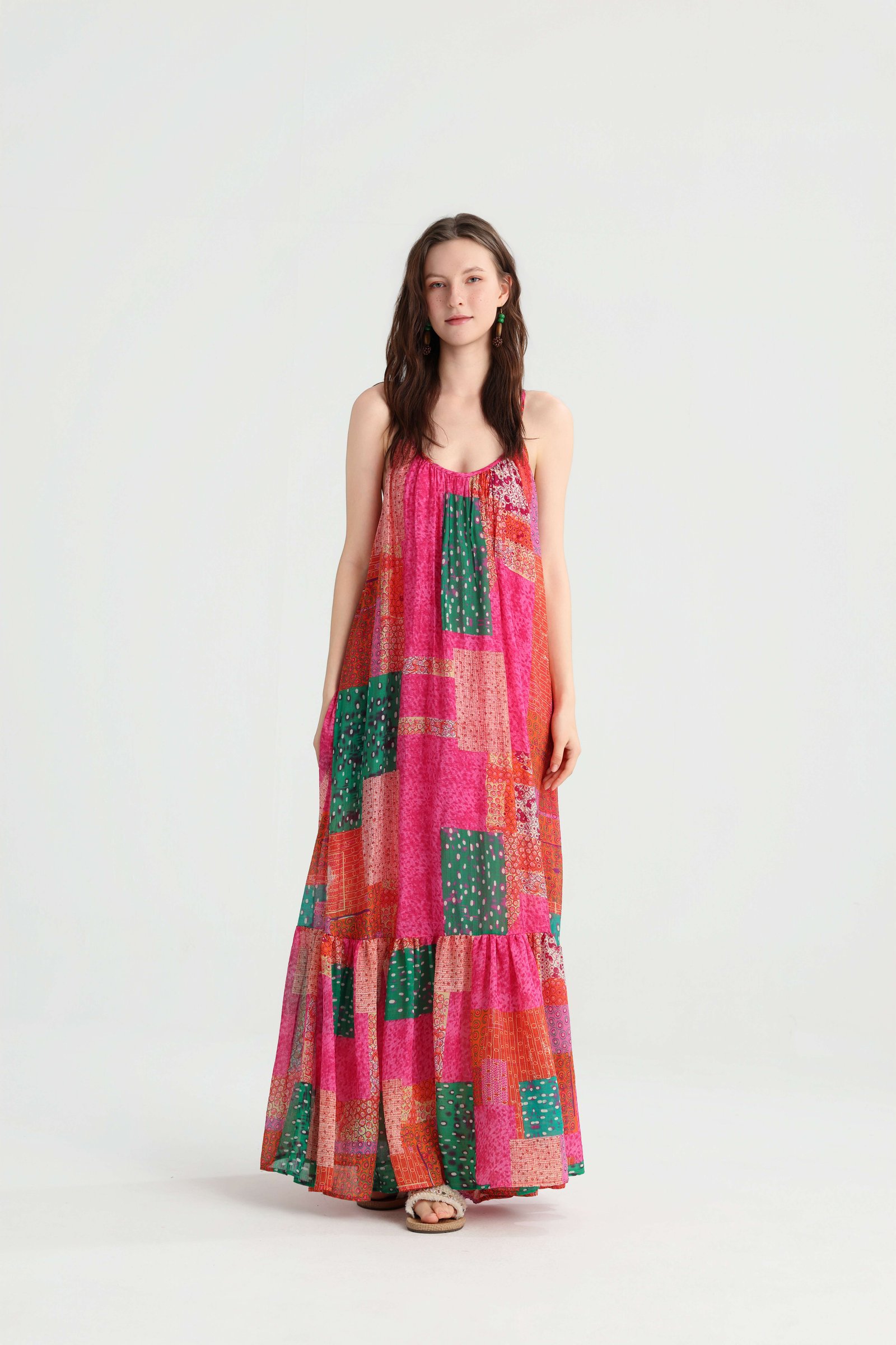 Front view of a pink patchwork tiered maxi dress with spaghetti straps and a loose silhouette