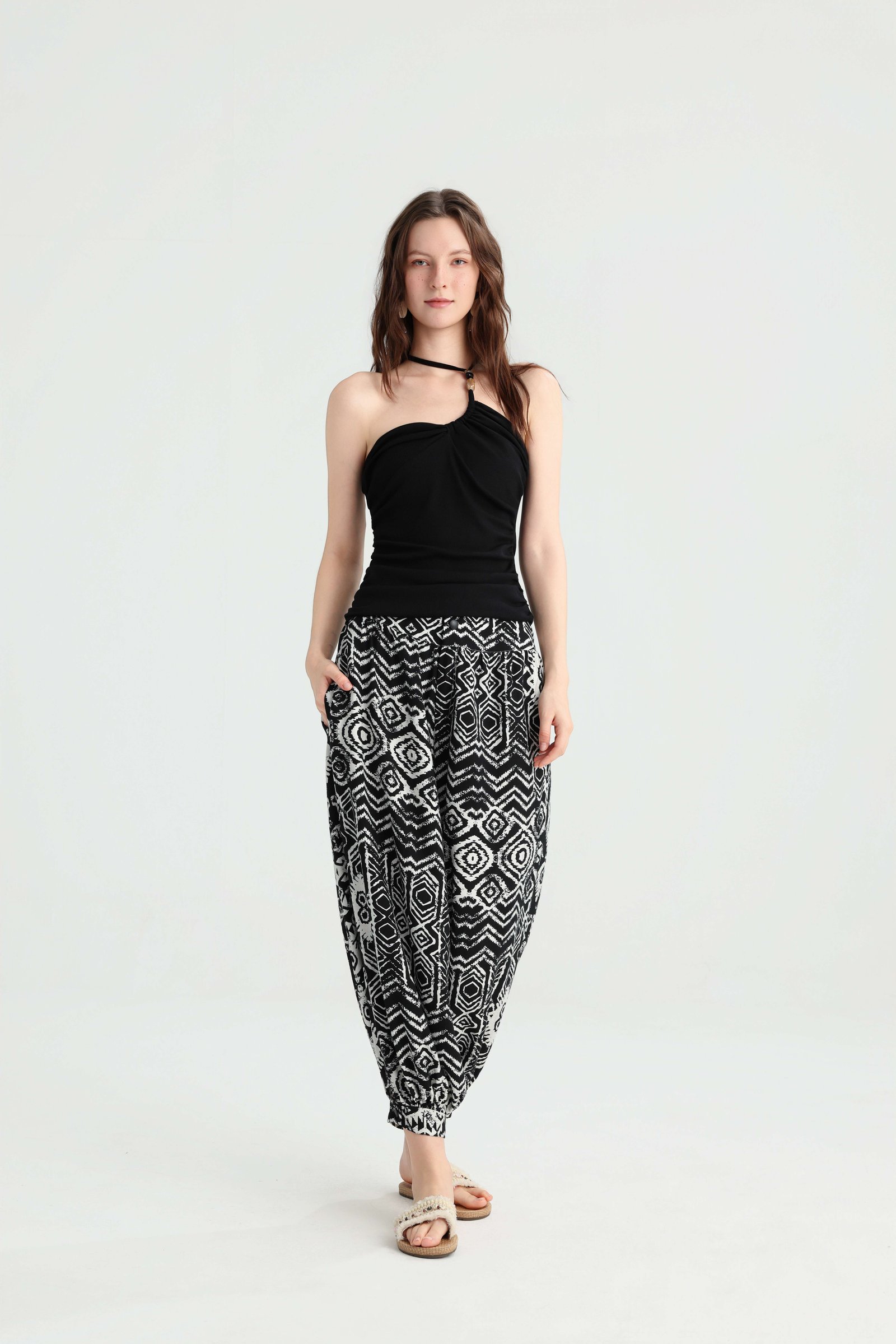 Black asymmetric halter top styled with black and white harem pants