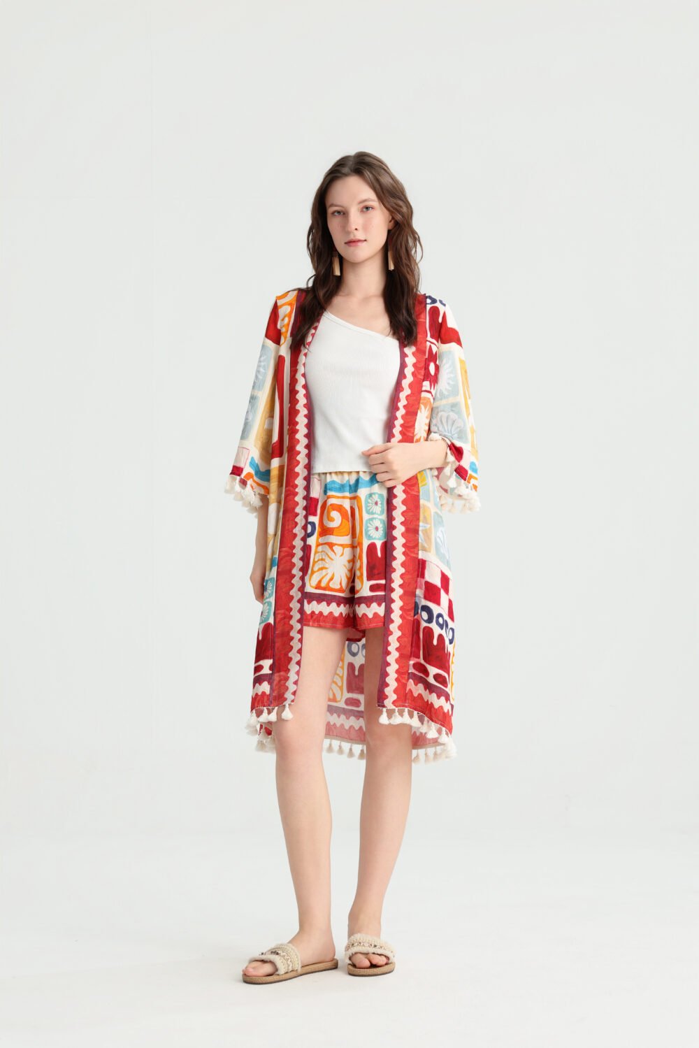 Front view of a model wearing a multicolor abstract print kimono shorts set with tassel trim