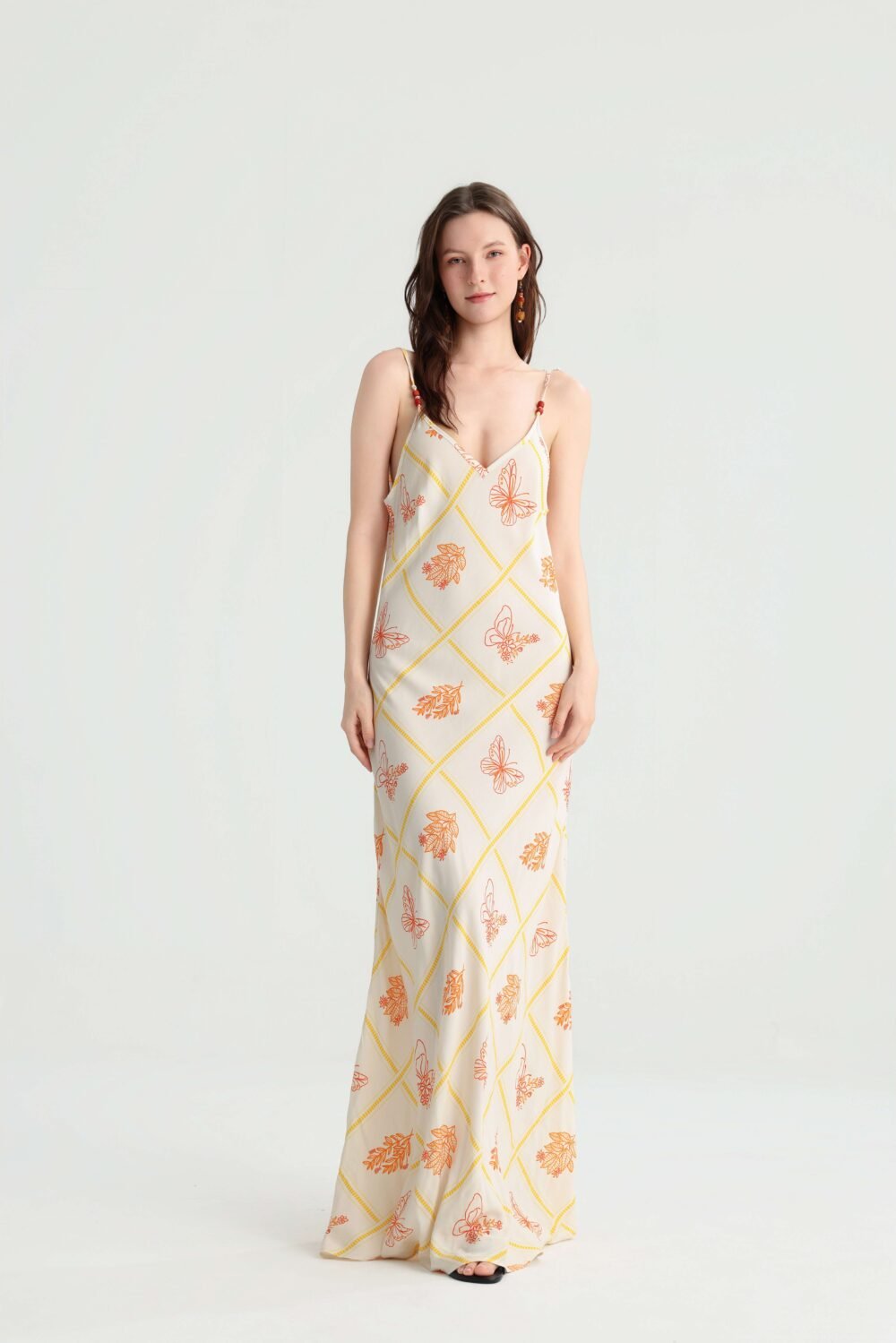 Front view of an ivory butterfly print spaghetti strap maxi dress