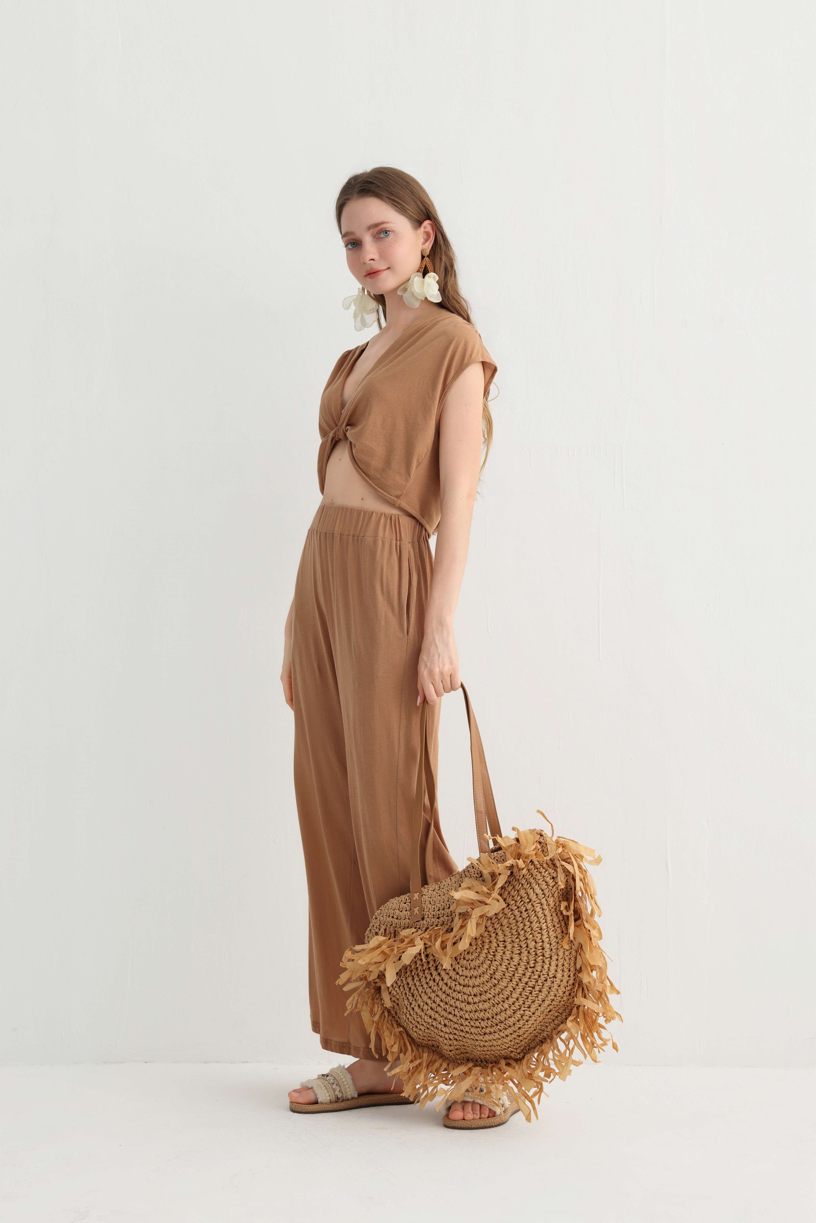 Angled view of the camel crop top and wide leg pants set